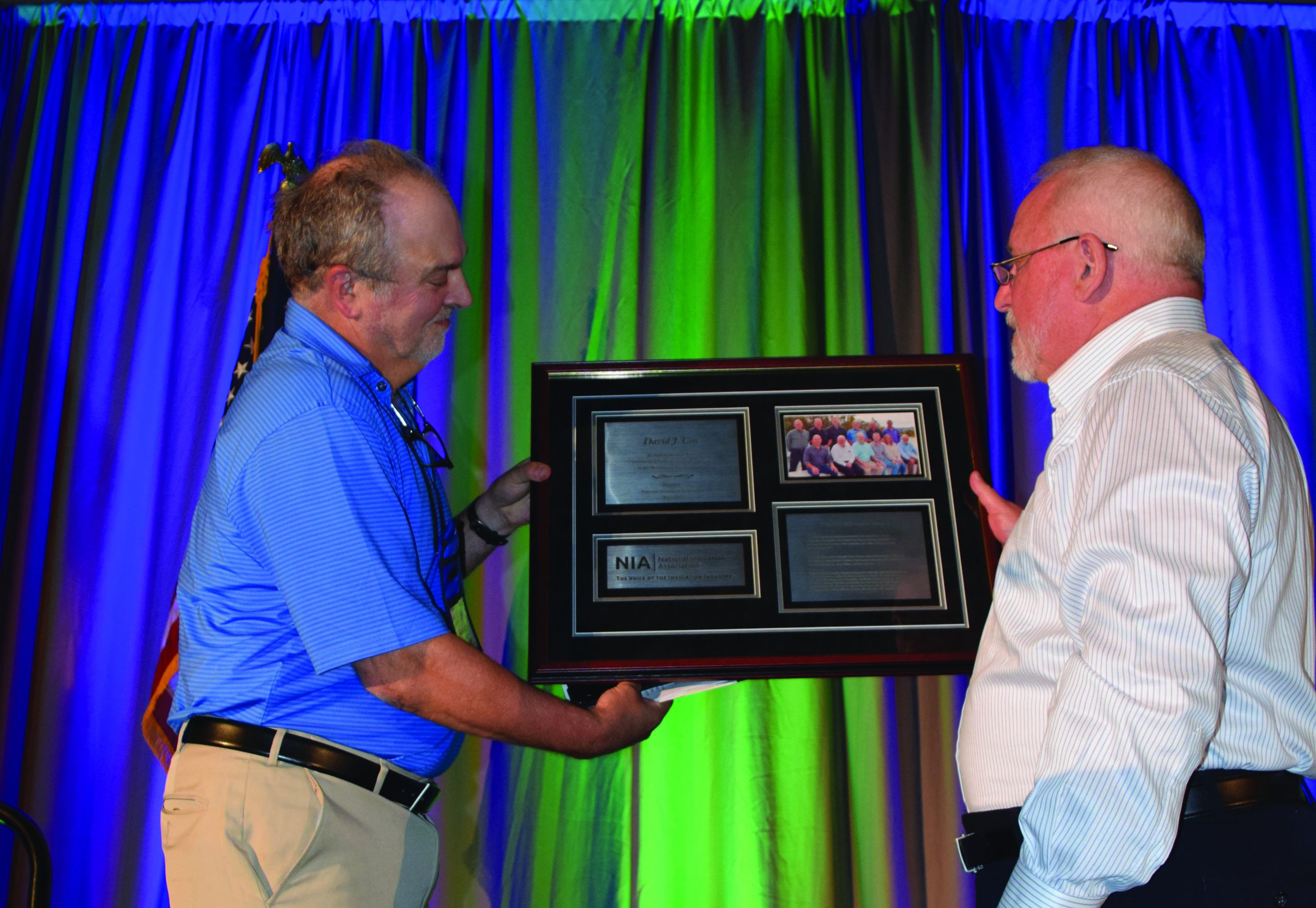 Outgoing NIA President receives an industry award presented by incoming President Joe Leo
